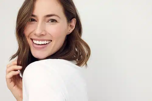 closeup,portrait,of,young,happy,woman,looking,in,camera
