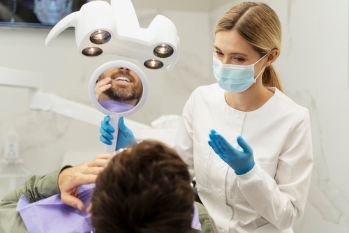 portrait,of,dentist,wearing,protective,mask,,consultation,patient.,male,patient