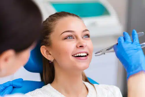 woman at dentist getting a tooth extracted